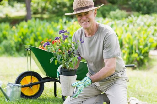 Gardener pruning shrubs in Hatch End